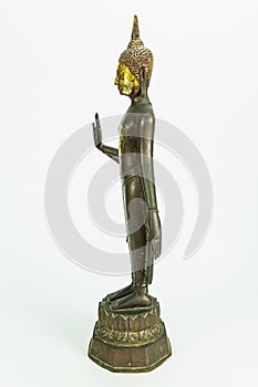 Lateral side of ancient Buddha metal statue isolated on white background