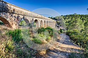 Lateral view on archade of roman aqueduct near Tarragona, Spain photo