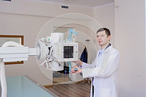 lateral view of a male radiologist adjusting the X-ray machine