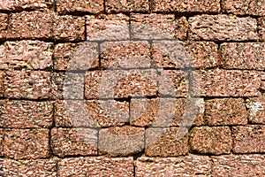 A laterite wall made of blocks photo