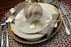 Latest trend of gold metallic theme Christmas formal dinner table place setting - close up