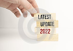 latest update 2022 word written on wood block. Time to update text on wooden table