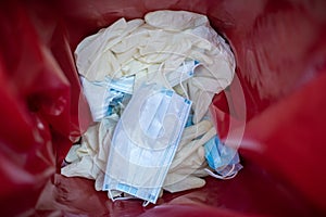 Latex gloves and mask inside medical waste bin