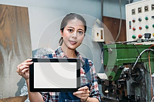 Lathe female worker holding mobile digital tablet