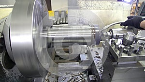 Lathe machine produces metal detail on factory. Drilling the blank on the lathe.