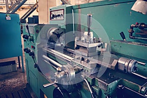 Lathe, metal processing by cutting on industrial equipment. Tinted image.