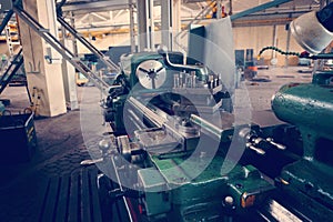 Lathe, metal processing by cutting on industrial equipment. Tinted image.