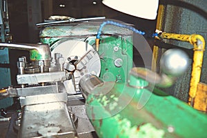 Lathe, metal processing by cutting on industrial equipment. Tinted image.