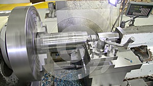 The lathe produces the metal part at the factory. Working metal lathe.