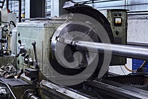 Lathe with a workpiece fixed in the spindle faceplate in the workshop