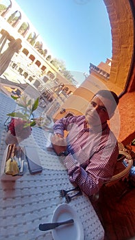 Latin adult man eats in the colonial city Zacatecas Mexico on his weekend walk rests and relaxes on vacation