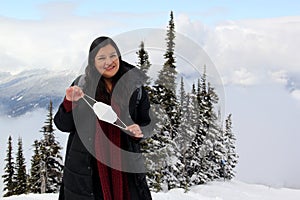 Latin adult woman arrives in Canada and discovers the snowy mountains with a face mask due to the Covid-19 pandemic in the new nor