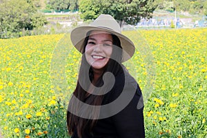 Latin adult woman in field of yellow flowers, day of the dead flower in Cholula Puebla Mexico