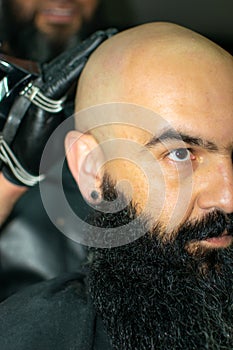 Latin American barber working the style with a long beard in the city of Bogot photo