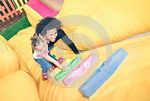 Latin american dad playing with mixed race daughter at playroom