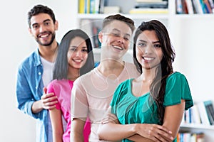 Latin american girl with group of friends in a row