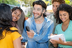 Latin american male journalist with group of reporters at interview