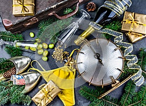 LATIN AMERICAN AND SPANISH NEW YEAR TRADITIONS. empty suitcase, lentil spoon, yellow interior clothes, gold ring in photo