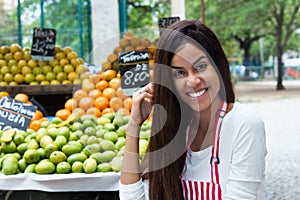 Latin american woman selling fruits at farmers market