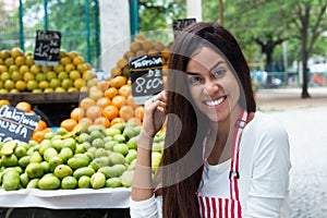 Latin american woman selling fruits at farmers market photo