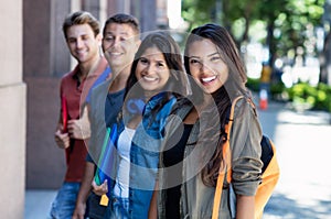 Latin american young adult woman with group of students in line