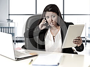 Latin business woman suffering stress working at office computer desk worried