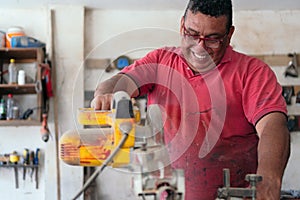 Carpenter using a circular saw in the workshop