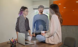 Latin colleagues having business conversation during coffee break in coworking office