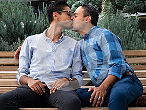 Latin couple gay men sitting on a bench, gay concept