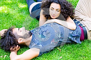 Latin Couple on meadow sleeping in summer