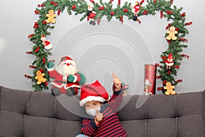 Latin family, grandmother, mom and child with protection mask and santa claus hat, christmas decoration, new normal covid-19
