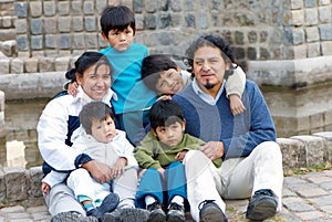 Latin family sitting in the street photo