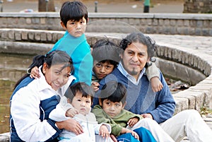 Latin family sitting in the street