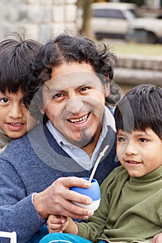 Latin family sitting in the street