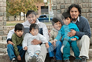 Latin family sitting in the street