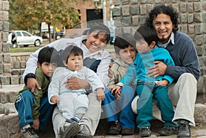 Latin family sitting in the street