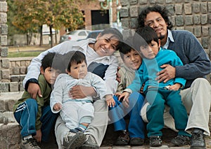 Latin family sitting in the street