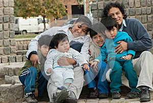 Latin family sitting in the street