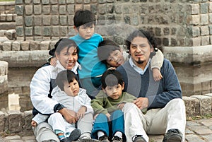 Latin family sitting in the street