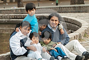 Latin family sitting in the street