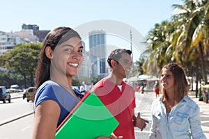 Latin female student with friends in the city