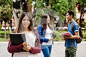 Latin female student, Hispanic girl in Mexico and group of mexican students at Background in Mexico