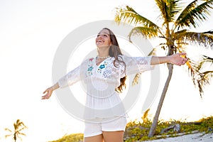 Latin girl happy open arms in Caribbean beach