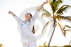 Latin girl happy open arms in Caribbean beach