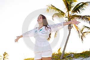 Latin girl happy open arms in Caribbean beach