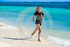 Latin girl running in caribbean shore beach