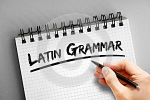 Latin grammar text on notepad, concept background