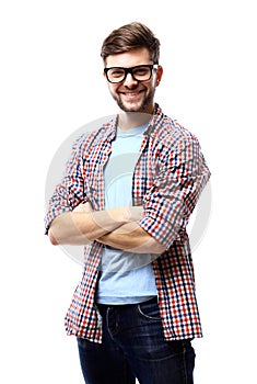 Latin hipster guy wearing glasses with his arms crossed and smiling on white background