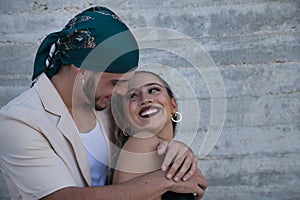 Latin and Hispanic boy and girl couple, young and nonconformist, looking at each other in love hugging each other happily and photo