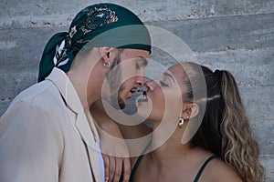 Latin and Hispanic boy and girl couple, young and nonconformist, looking at each other in love with their noses glued together photo